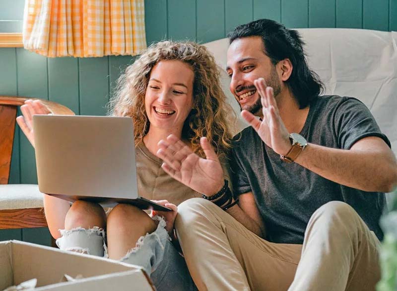 Two People Looking at a Laptop